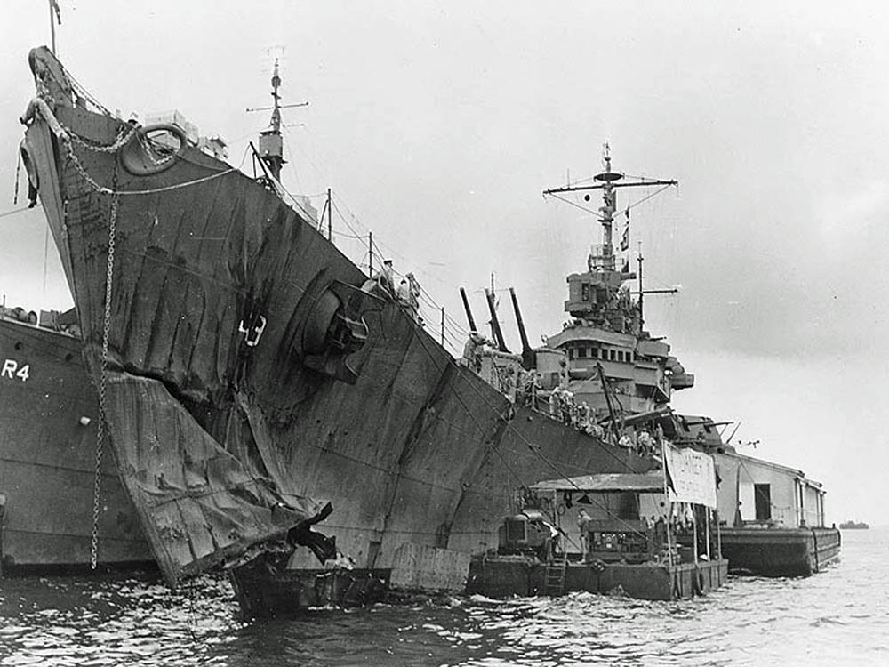 Light cruiser USS St. Louis with torpedo damage to her bow after the Battle of Kolombangara, photographed while under repair at Tulagi in July 1943. USS Vestal (AR-4) is alongside. (U.S. Navy Photograph.)