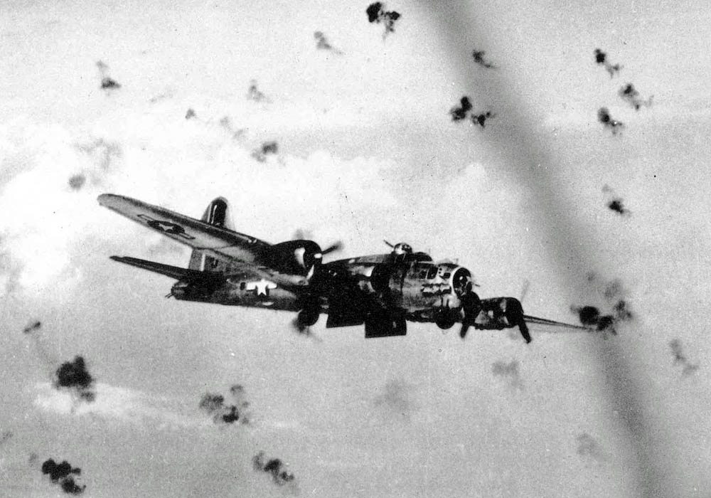 Boeing B-17 Flying Fortress flies through heavy flak over the target during World War II. (U.S. Air Force Photograph.)