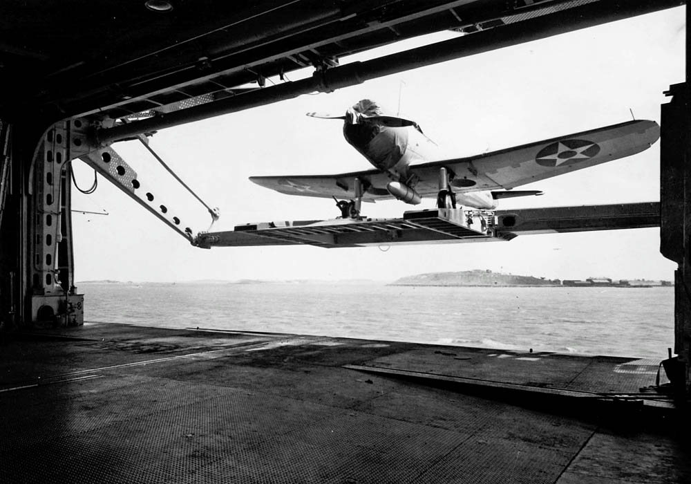 A Vought SB2U-2 Vindicator from the U.S. Navy scouting squadron VS-72 is raised on the elevator of the aircraft carrier USS Wasp (CV-7) in June 1940. (U.S. Navy Photograph.)