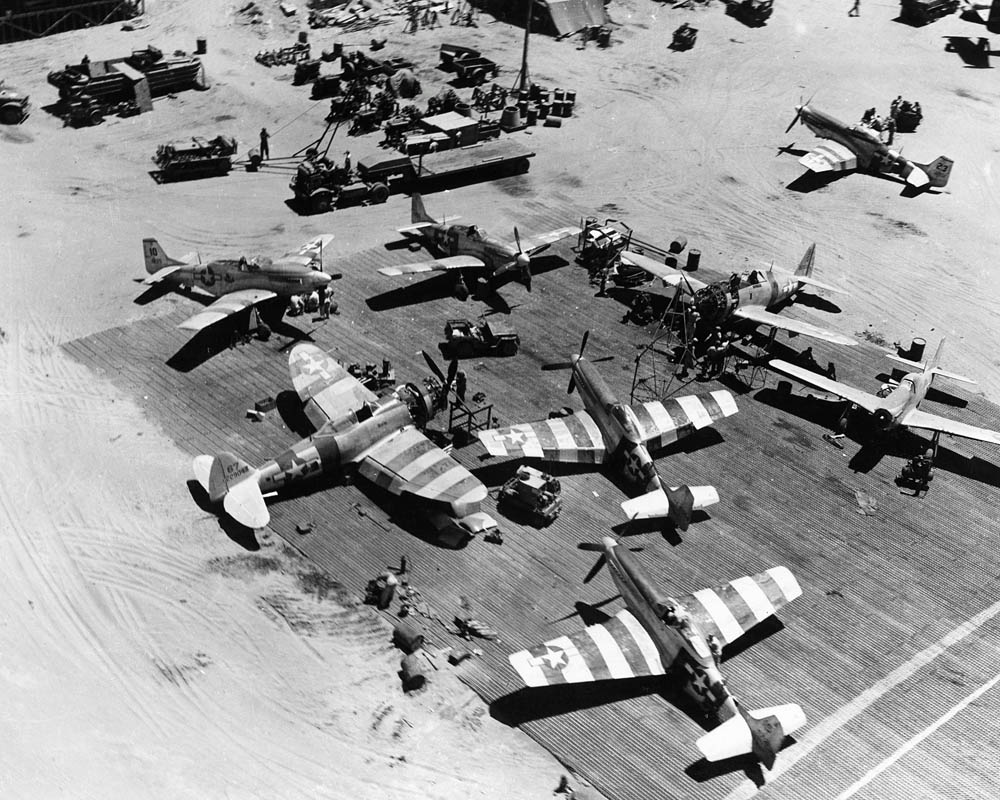 Maintenance work on North American P-51D Mustangs and Republic P-47D Thunderbolts is performed at Lingayen Airfield in the Philippines in April 1945. (U.S. Air Force Photograph.)