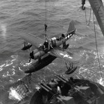A Vought OS2U Kingfisher is recovered by the U.S. Navy battleship USS Texas off the shore of Iwo Jima in February 1945. (U.S. Navy Photograph.)