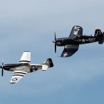 A P-51 Mustang fighter and a F4U Corsair fighter pass over audiences at the Tampa Bay Air Fest at MacDill Air Force Base, Tampa, Fla., on March 20, 2016. U.S. Army Photograph by Capt. Yau-Liong Tsai / Released.