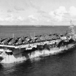 The Independence-class light aircraft carrier USS Monterey (CVL 26) is shown at anchor in the Ulithi Atoll, Caroline Islands with a group of F-6F fighter aircraft on the flight deck, November 1944. (U.S. Navy Photograph.)