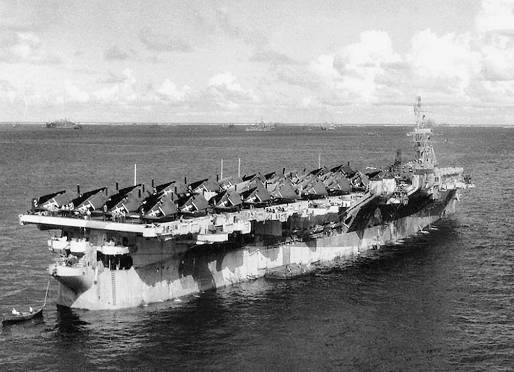 The Independence-class light aircraft carrier USS Monterey (CVL 26) is shown at anchor in the Ulithi Atoll, Caroline Islands with a group of F-6F fighter aircraft on the flight deck, November 1944. (U.S. Navy Photograph.)