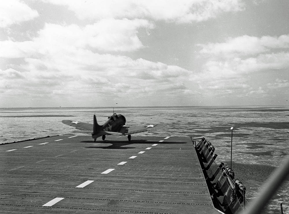 An SBD Dauntless dive bomber takes off from the training aircraft carrier USS Wolverine (IX-64) in March 1943. (U.S. Navy Photograph.)