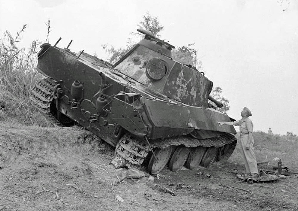 The remains of a destroyed German Panther tank sit on the roadside near Trarivi, Italy in September 1944. (Imperial War Museum Photograph.)