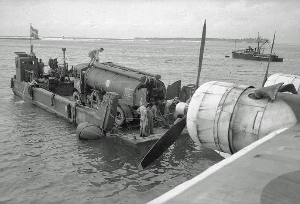 An RAF Short Sunderland GR Mark V of No. 205 Squadron moored off Direction Island, Cocos Islands prepares to refuel from a petrol tanker on board a Tank Landing Craft. (Imperial War Museums Photograph.)