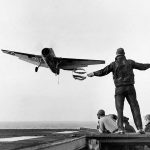 A Grumman TBF-1 Avenger is guided to a landing on the USS Card (ACV-11) by a Landing Signal Officer in 1943. (U.S. Navy Photograph.)