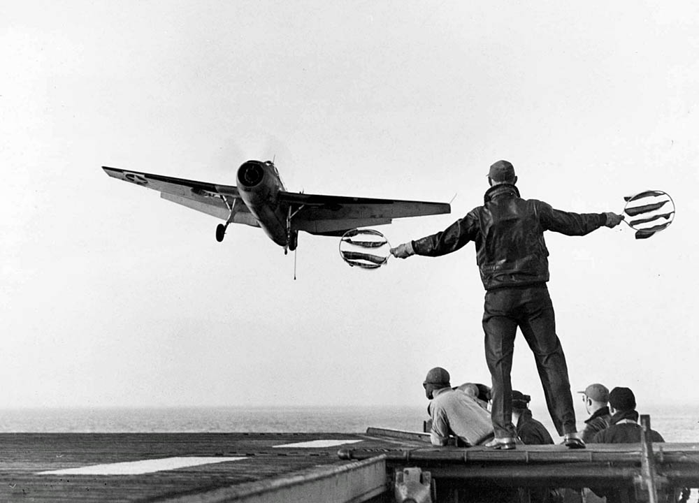 A Grumman TBF-1 Avenger is guided to a landing on the USS Card (ACV-11) by a Landing Signal Officer in 1943. (U.S. Navy Photograph.)