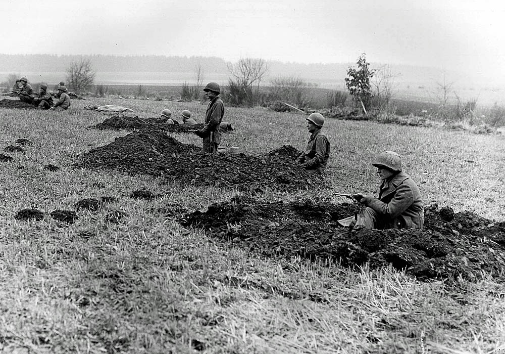 U.S. Army soldiers from the 630th Tank Destroyer Battalion dig positions on a hill near Wiltz, Belgium during the Battle of the Bulge in December 1944. (Signal Corps Photograph.)