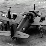 Sailors test the machine guns of a Grumman F4F-4 Wildcat of Fighting Squadron Six (VF-6) on the flight deck of the aircraft carrier USS Enterprise (CV-6) in April 1942. (U.S. Navy Photograph.)