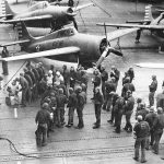 Sailors gather in front of Grumman F4F-4 Wildcats from Fighting Squadron 6 (VF-6) aboard the aircraft carrier USS Enterprise (CV-6) in April 1942. (U.S. Navy Photograph.)