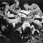 Factory workers assemble the cylinders on an early production Pratt and Whitney R-2800 Double Wasp radial aircraft engine in June 1942. (U.S. National Archives and Records Admin. Photograph.)