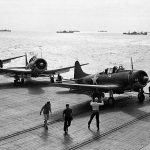 U.S. Navy Douglas SBD Dauntless dive bombers from VC-29 prepare for antisubmarine patrol on the flight deck of the escort carrier USS Santee (ACV-29) during operations in the Atlantic. (U.S. Navy Photograph.)