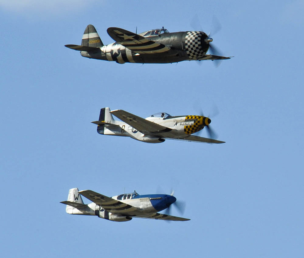 A P-47 Thunderbolt and two P-51 Mustangs fly in formation during 2015 Heritage Flight training at Davis-Monthan Air Force Base, Arizona, Feb. 28, 2015. (U.S. Air Force Photo by Airman 1st Class Chris Massey / Released.)
