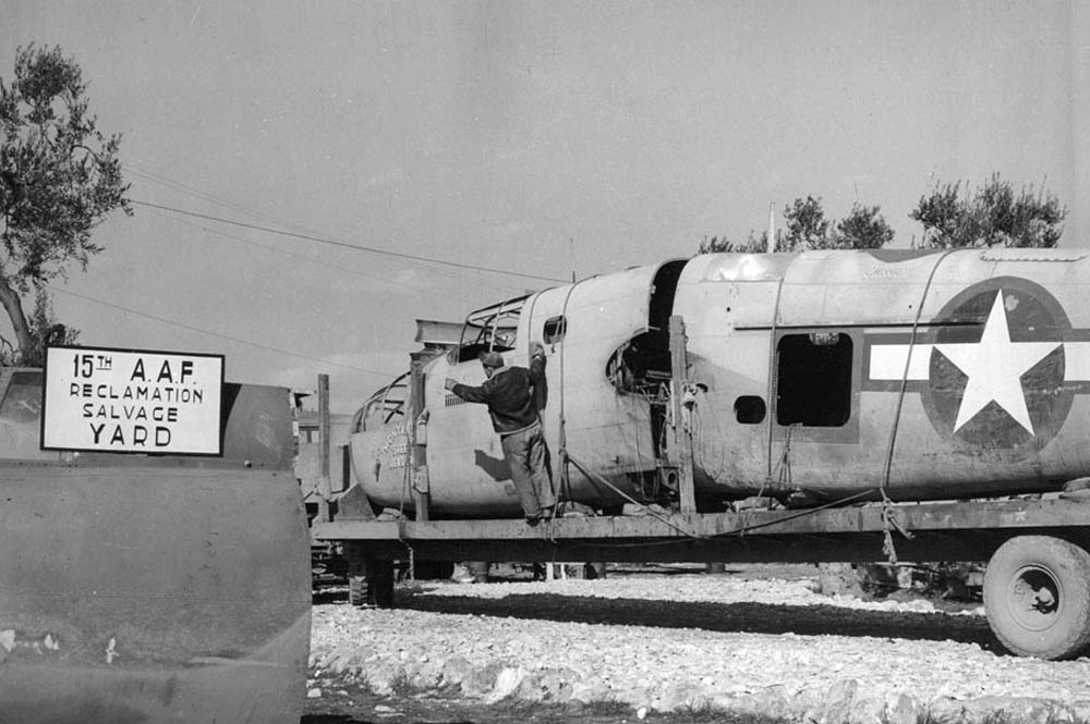 The fuselage of the veteran Montana Sheep Herder, a B-25D Mitchell of the 446th BS, 321st BG, is trucked into a 15th Air Force salvage yard in North Africa. (U.S. Air Force Photograph.)