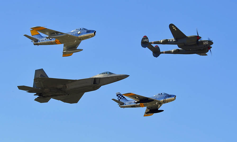 A P-38 Lightning leads an aircraft formation of an F-22 Raptor and F-86 Sabres during the 2015 Heritage Flight Training and Certification Course at Davis-Monthan Air Force Base, Arizona. (U.S. Air Force Photograph by S/Sgt. Courtney Richardson / Released.)
