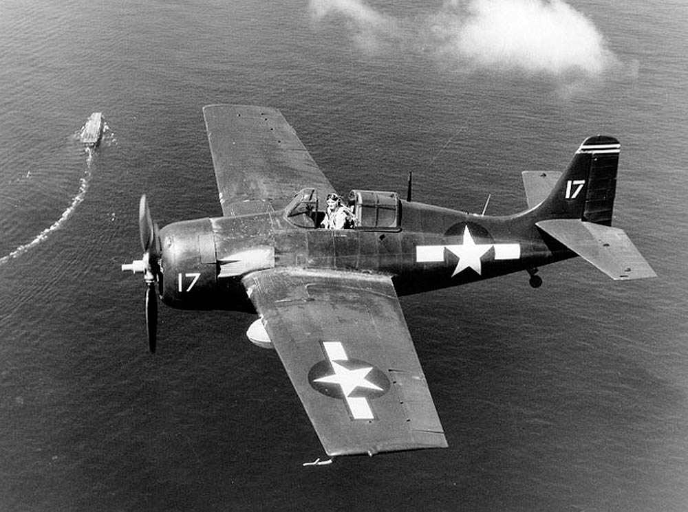A U.S. Navy FM-2 Wildcat fighter flies a combat air patrol over the escort carrier USS Santee (CVE-29) during the Leyte Invasion in October 1944. (Official U.S. Navy Photograph.)