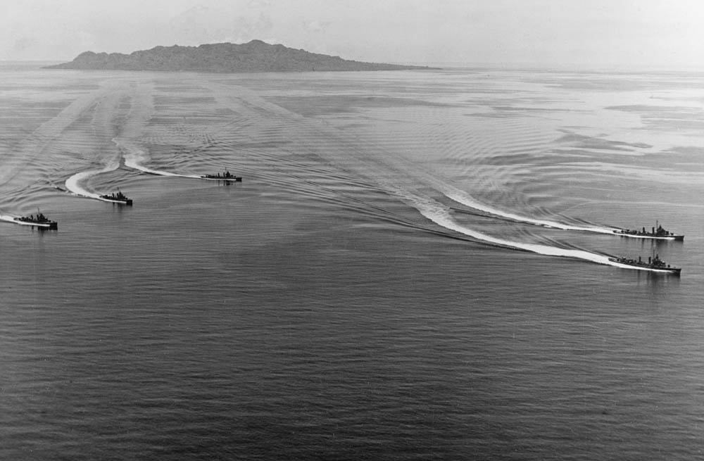 U.S. Navy Destroyer Squadron 12 (DesRon 12) salutes the dead with S-turns in Ironbottom Sound in March 1944. The destroyers are USS Farenholt (DD-491), USS Buchanan (DD-484), USS Woodworth (DD-460), USS Lardner (DD-487) and USS Lansdowne (DD-486). (Official U.S. Navy Photograph.)