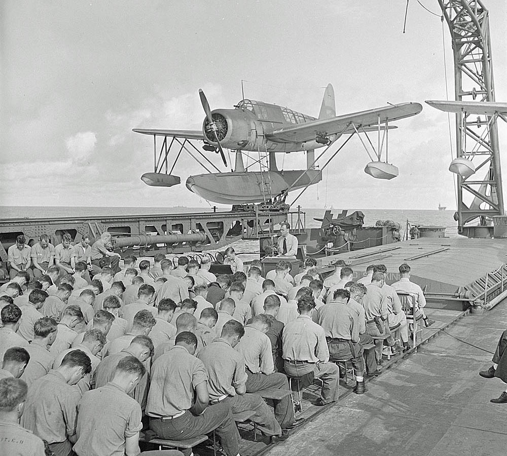 Sunday religious services on board the USS Mobile (CL-63) in August 1943. (National Archives and Records Administration.)