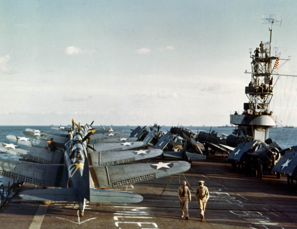 Dauntless dive bombers and Grumman Wildcat fighters are parked on the deck of escort carrier USS Santee (ACV-29) during Operation Torch in November 1942. (Official U.S. Navy Photograph.)