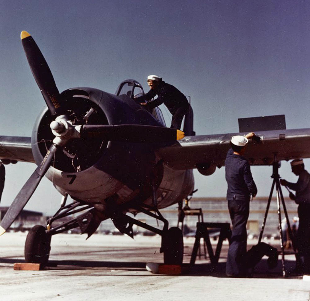 A Grumman F4F-4 Wildcat fighter undergoes maintenance at an air base in the United States, circa 1942-43. (Official U.S. Navy Photograph.)
