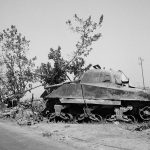 An M4 Sherman tank knocked out near Catania, Sicily with a German 88mm in the background. (U.S. Library of Congress Photograph.)
