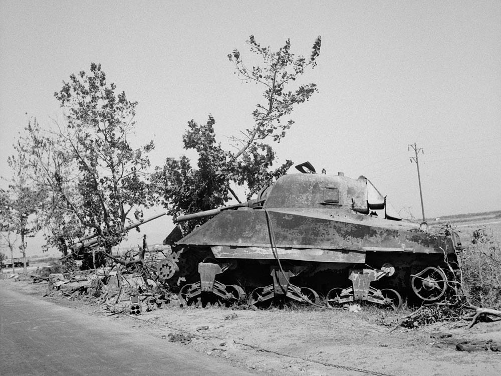 An M4 Sherman tank knocked out near Catania, Sicily with a German 88mm in the background. (U.S. Library of Congress Photograph.)
