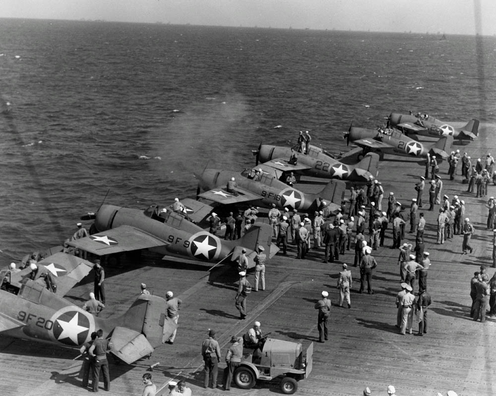 A lineup of U.S. Navy Grumman F4F-4 Wildcat fighters from Fighting Squadron 9 (VF-9) and Fighting Squadron 41 (VF-41), of Carrier Air Group Four (CVG-4), calibrate guns aboard the aircraft carrier USS Ranger (CV-4) in November 1942. (Official U.S. Navy Photograph.)
