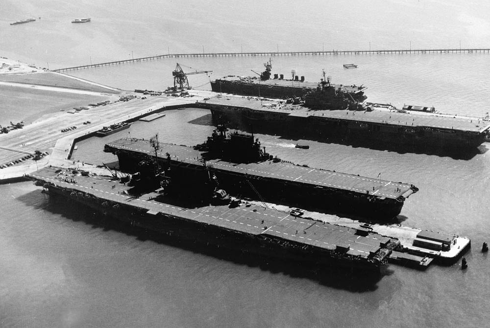 After the end of WWII, the four U.S. Navy aircraft carriers USS Saratoga (CV-3), USS Enterprise (CV-6), USS Hornet (CV-12) and USS San Jacinto (CVL-30), from foreground to background, docked at Naval Air Station Alameda, California in September 1945. (U.S. Navy Photograph.)