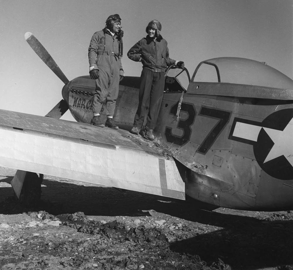Photographer Toni Frissell stands on the wing of a P-51 Mustang with Major George S. Roberts at Ramitelli, Italy in March 1945. (Library of Congress Photograph.)
