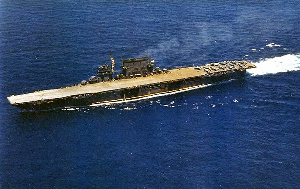 The U.S. Navy aircraft carrier USS Saratoga (CV-3) underway with Grumman F4F-4 Wildcats, Douglas SBD-3 Dauntlesses, and a Grumman TBF-1 Avenger visible on the deck. (U.S. Navy Photograph.)