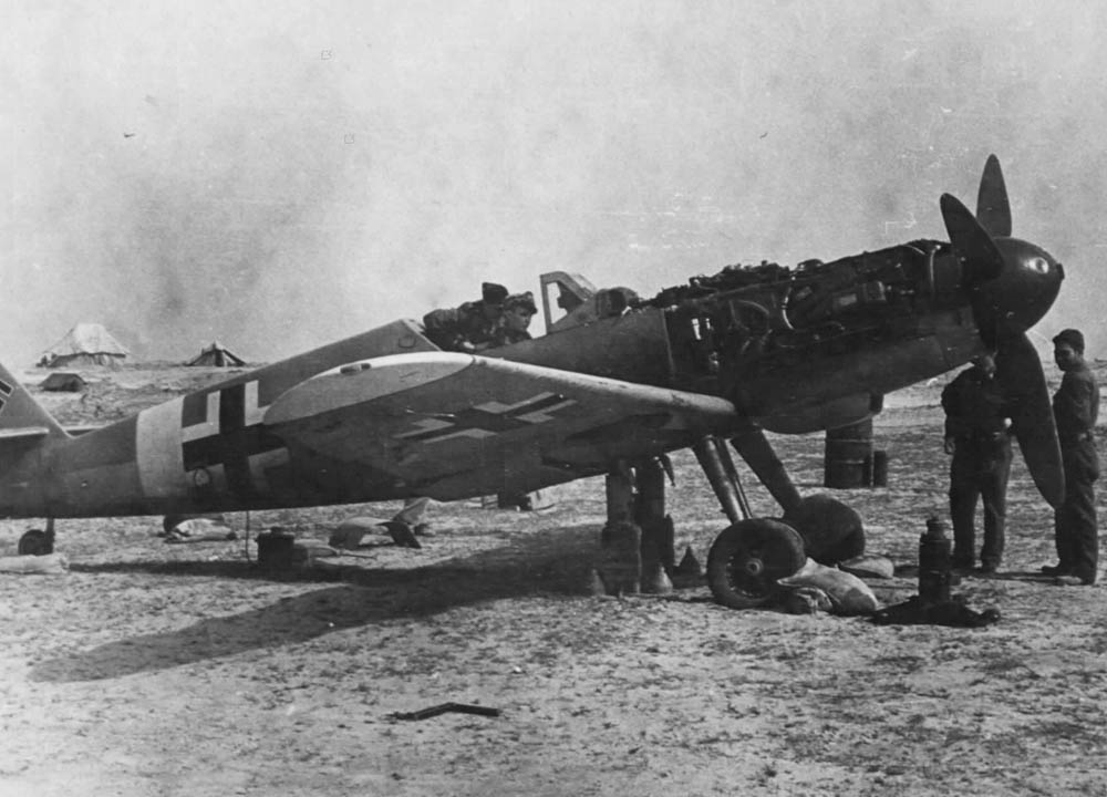 Soldiers of the 87th Fighter Squadron work on a captured Messerschmitt Bf 109G fighter in Tunisia, April 1943. (U.S. Air Force Photograph)