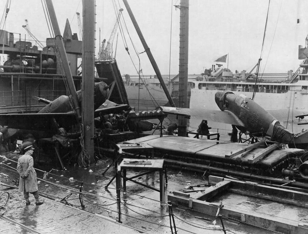 Original Caption: View of the deck of a ship upon arrival at Glasgow, Scotland after heavy seas washed one plane overboard and forced two others from their lashings causing considerable damage. The planes were being transported from the United States for use in the ETO. 23 January 1944. (U.S. Air Force Photograph.)