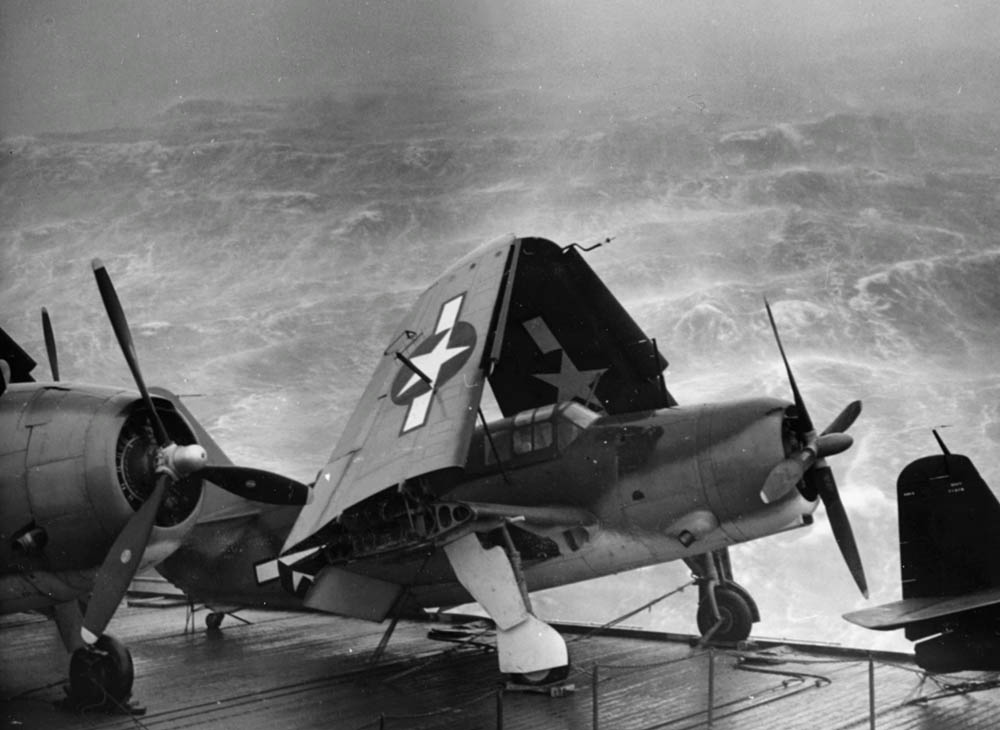 Curtiss SB2C-3 Helldivers strapped to the deck of the U.S. Navy escort carrier USS Kwajalein (CVE-98) during a typhoon in December 1944. (Official U.S. Navy Photograph.)