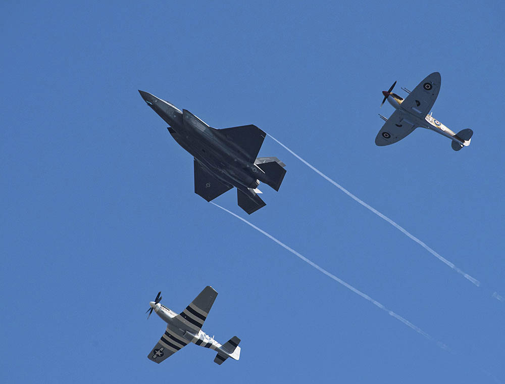 A U.S. Air Force F-35A Lightning II, P-51D Mustang and VS Spitfire fly in formation in a USAF heritage flight during the 2018 Royal International Air Tattoo (RIAT) at RAF Fairford in July 2018. (U.S. Air Force Photograph by TSgt Brian Kimball.)