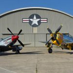 Two classic American WWII fighters, the North American P-51D Mustang and the Republic P-47D Thunderbolt, await moving into the WWII Gallery at the National Museum of the U.S. Air Force. (U.S. Air Force Photo by Ken LaRock.)