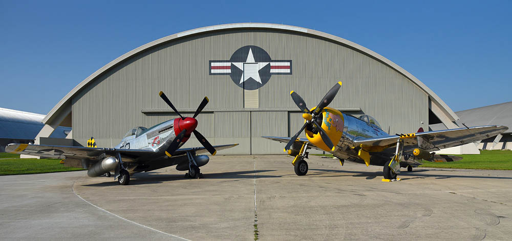 Two classic American WWII fighters, the North American P-51D Mustang and the Republic P-47D Thunderbolt, await moving into the WWII Gallery at the National Museum of the U.S. Air Force. (U.S. Air Force Photo by Ken LaRock.)