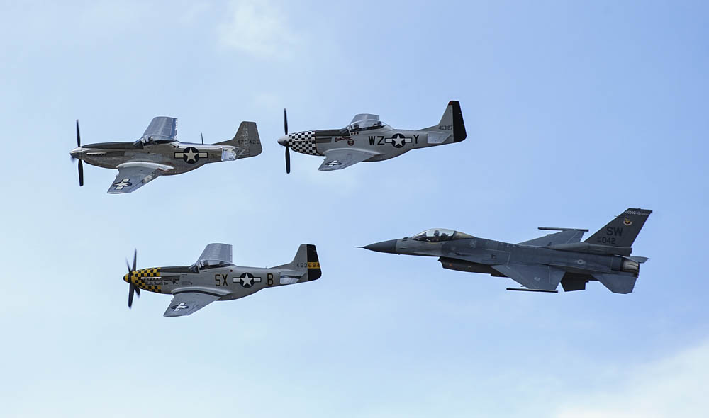 A trio of P-51 Mustangs fly in formation with a U.S. Air Force F-16 Fighting Falcon during the 2017 Heritage Flight Training and Certification Course at Davis-Monthan Air Force Base, Arizona. (U.S. Air Force Photograph by Airman 1st Class Mya M. Crosby.)