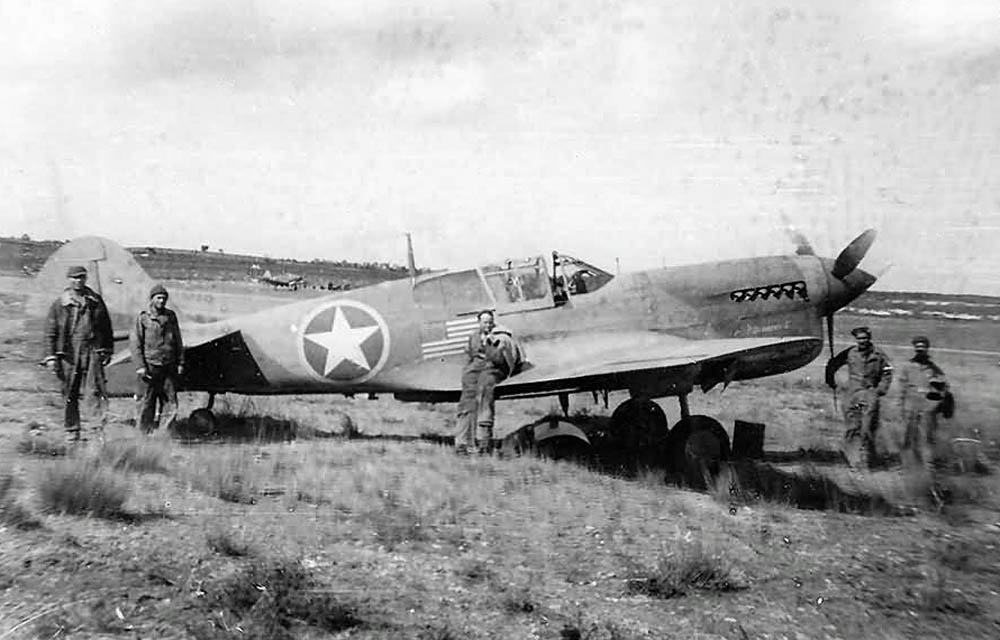 A Curtiss P-40 Warhawk fighter shows the American flag markings used for Operation Torch at airfield in North Africa. (U.S. Air Force Photograph.)