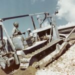A Seabee Caterpillar D7 medium bulldozer goes to work at the Construction Battalion Training Center, Camp Endicott, Davisville, Rhode Island, in the fall of 1943. (U.S. Navy Photograph.)