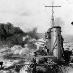 The heavy cruiser USS Salt Lake City (CA-25) fires her 8 inch/55 caliber guns while bombarding a Pacific island in February 1942. (U.S. Navy Photograph.)
