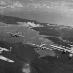 North American B-25 Mitchells from the 42nd Bombardment Group fly in formation over Bougainville from their base at Stirling Airfield, Solomon Islands in 1944. (U.S. Air Force Photograph.)