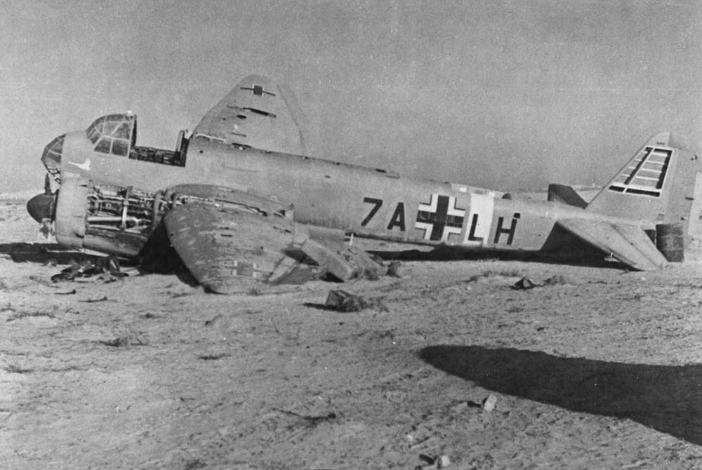 The wreck of a German Junkers Ju 88 lies abandoned in North Africa, typically identified as a reconnaissance variant belonging to Aufklärungsgruppe 121. (U.S. Air Force Photograph.)