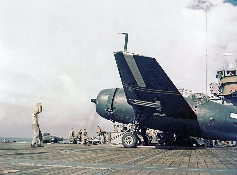 Sailors direct a rocket-armed TBM Avenger on the flight deck of  USS Cape Gloucester (CVE-109) during operations off Kyushu, Japan in September 1945. (U.S. Marine Corps Photograph.)