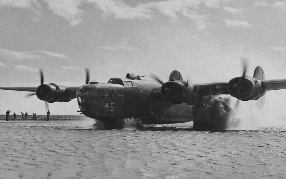 A Consolidated B-24 Liberator of the Fifteenth Air Force (15th AF) taxis down a flooded runway in Italy after heavy rains.  (U.S. Air Force Photograph.)