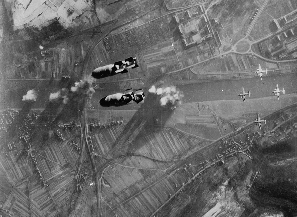 A formation of Martin B-26 Marauder bombers attack the railroad bridge across the Moselle River at Trier-Pfalzel, Germany in December 1944. (U.S. Library of Congress Photograph.)