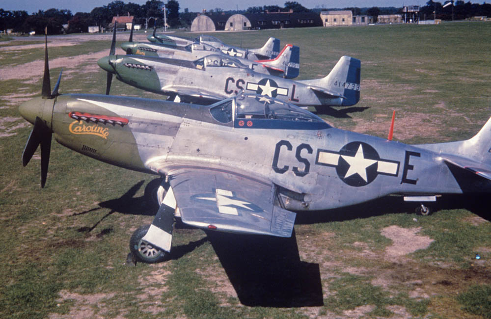 A lineup of P-51 Mustangs of the 359th Fighter Group are photographed in color at RAF East Wretham. (Imperial War Museums Photograph.)