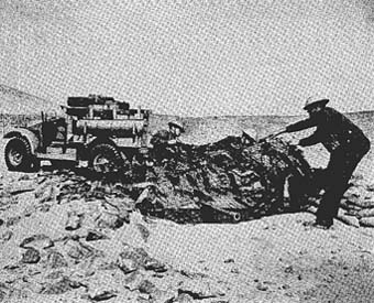 [Figure 22: British 2-pounder antitank gun being camouflaged in its gun pit]