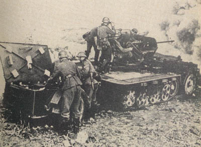 [Figure 4. 2-cm (20-mm) AA/AT gun 38 in action on self-propelled mount.]